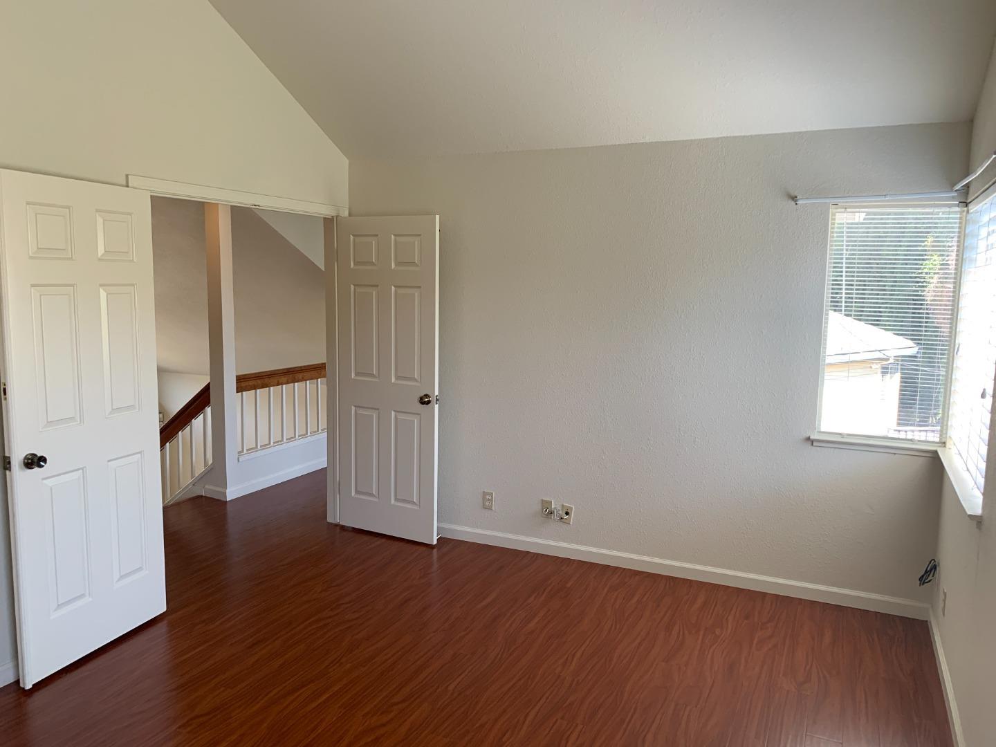 562 Costigan Circle Milpitas, CA 95035 - Photo 19 of 25 an empty room with wooden floor and windows
