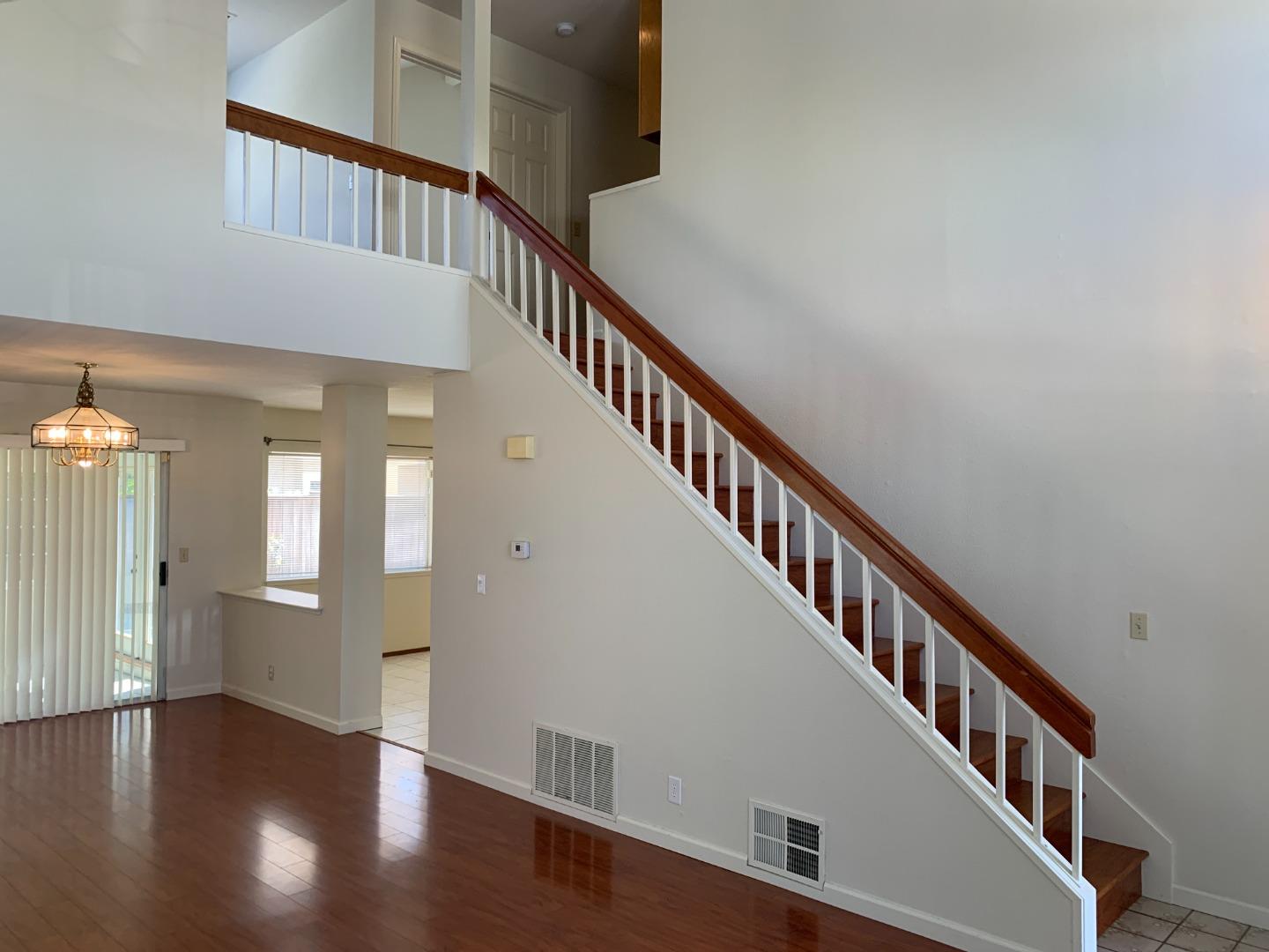 562 Costigan Circle Milpitas, CA 95035 - Photo 5 of 25 a view of an entryway wooden floor and stairs