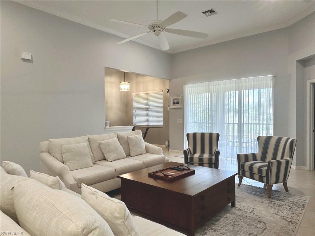 12259 Toscana Way, Unit 202 Bonita Springs, FL 34135 - Photo 11 of 40 a living room with furniture and a large window