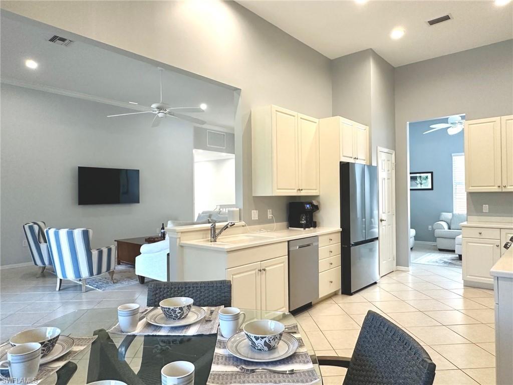 12259 Toscana Way, Unit 202 Bonita Springs, FL 34135 - Photo 12 of 40 a living room with furniture and a kitchen
