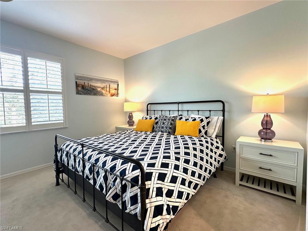 12259 Toscana Way, Unit 202 Bonita Springs, FL 34135 - Photo 16 of 40 a bedroom with a bed and window