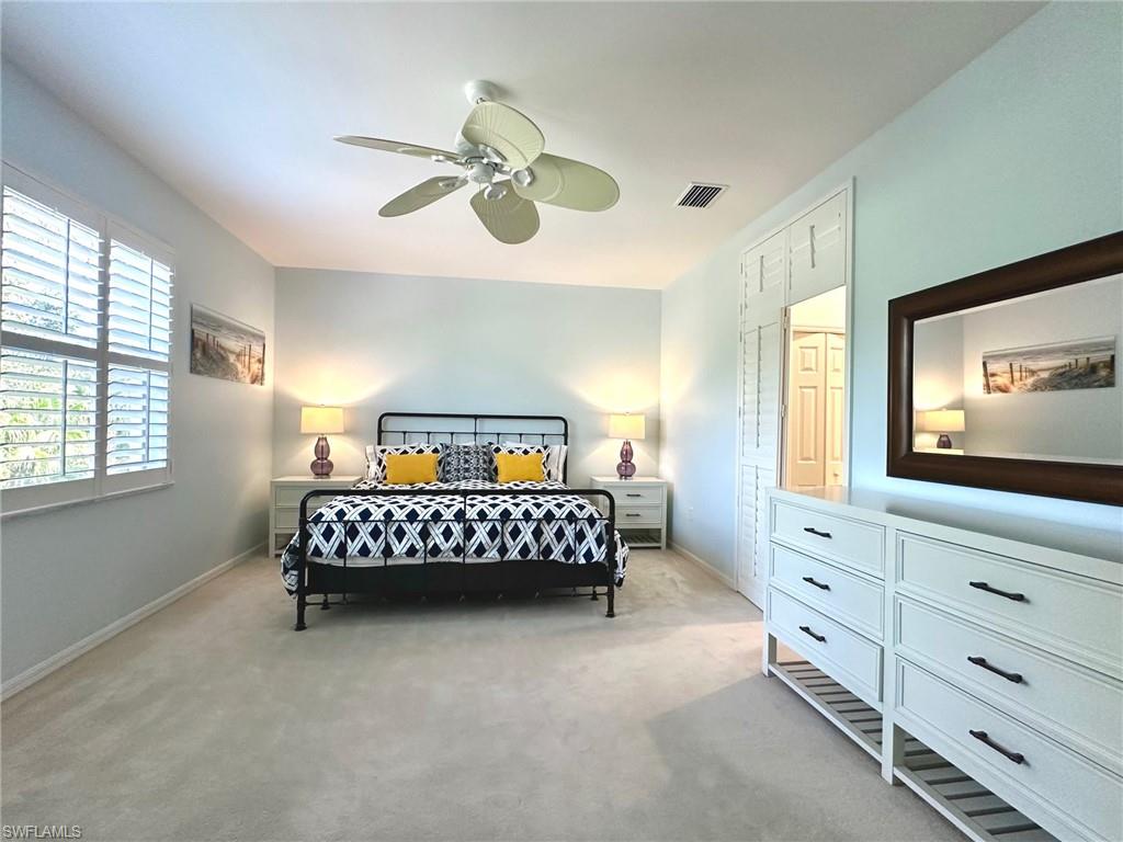 12259 Toscana Way, Unit 202 Bonita Springs, FL 34135 - Photo 17 of 40 a bedroom with a bed and a flat screen tv