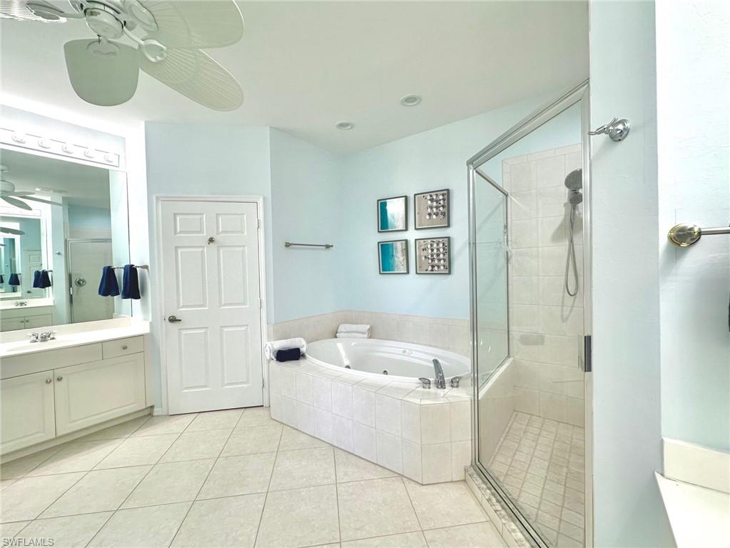 12259 Toscana Way, Unit 202 Bonita Springs, FL 34135 - Photo 20 of 40 a bathroom with a sink a mirror and a bathtub