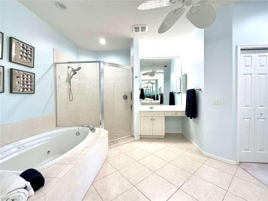 12259 Toscana Way, Unit 202 Bonita Springs, FL 34135 - Photo 21 of 40 a bathroom with a tub a sink and a mirror