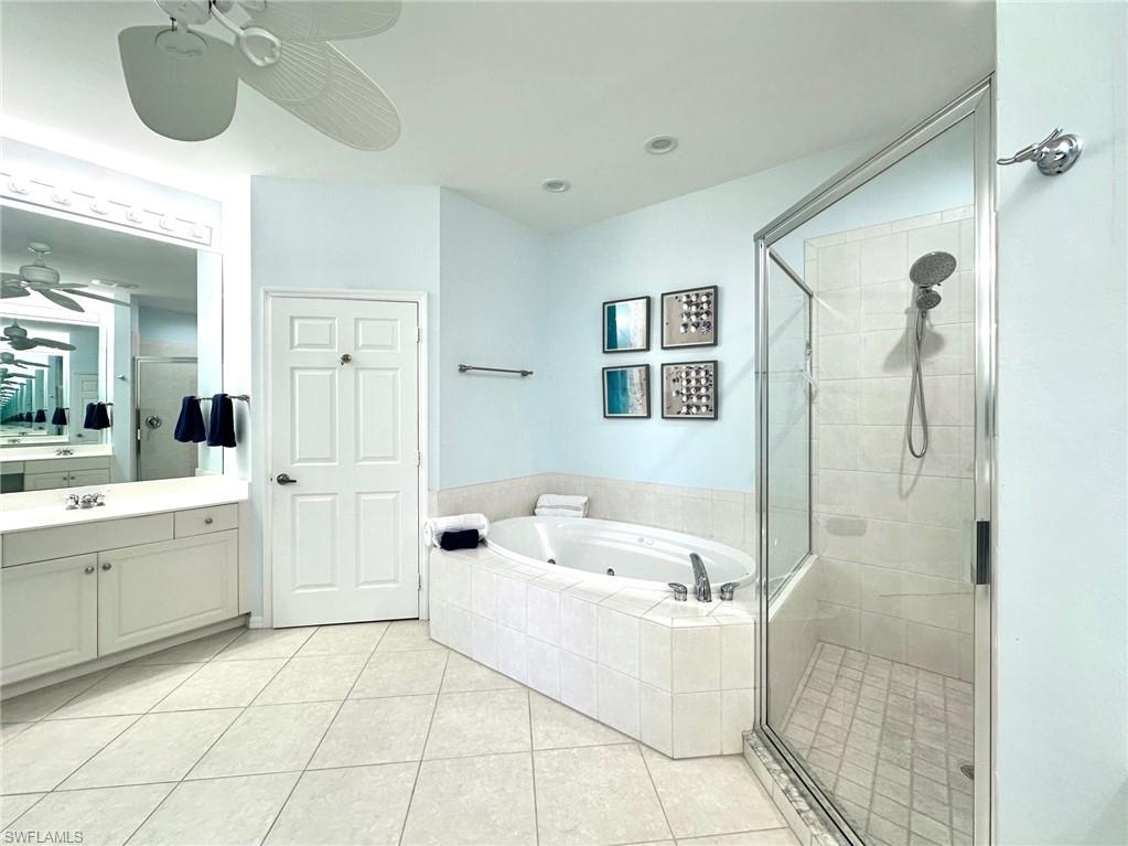 12259 Toscana Way, Unit 202 Bonita Springs, FL 34135 - Photo 22 of 40 a bathroom with a bathtub sink and mirror