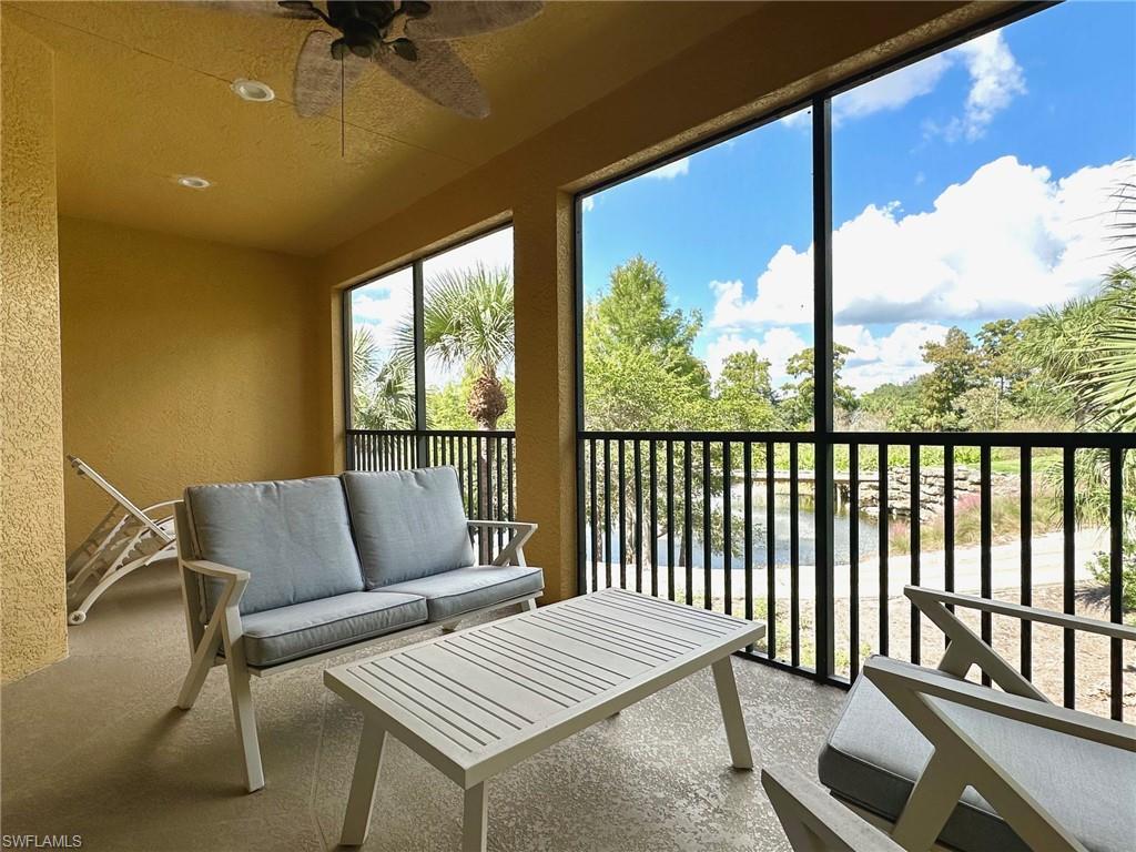 12259 Toscana Way, Unit 202 Bonita Springs, FL 34135 - Photo 25 of 40 a living room with furniture and a window