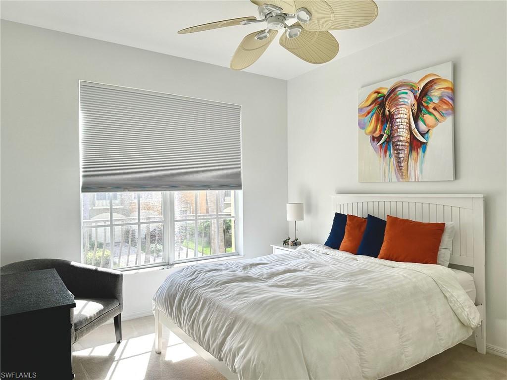 12259 Toscana Way, Unit 202 Bonita Springs, FL 34135 - Photo 26 of 40 a bedroom with a bed and a window
