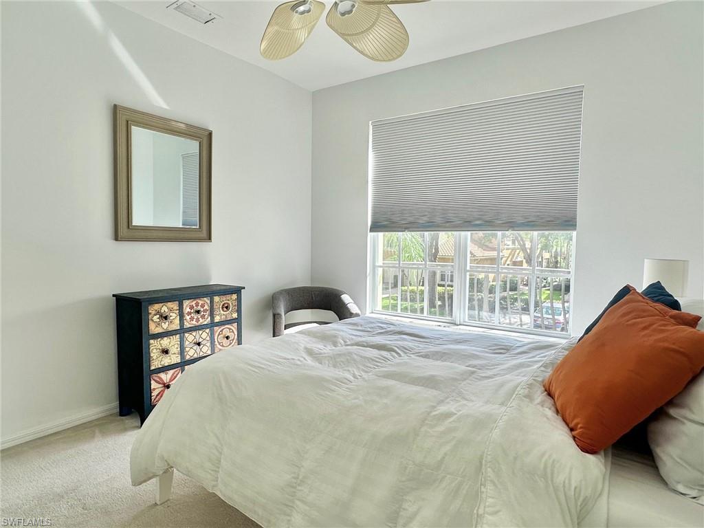 12259 Toscana Way, Unit 202 Bonita Springs, FL 34135 - Photo 27 of 40 a bedroom with a bed and a window