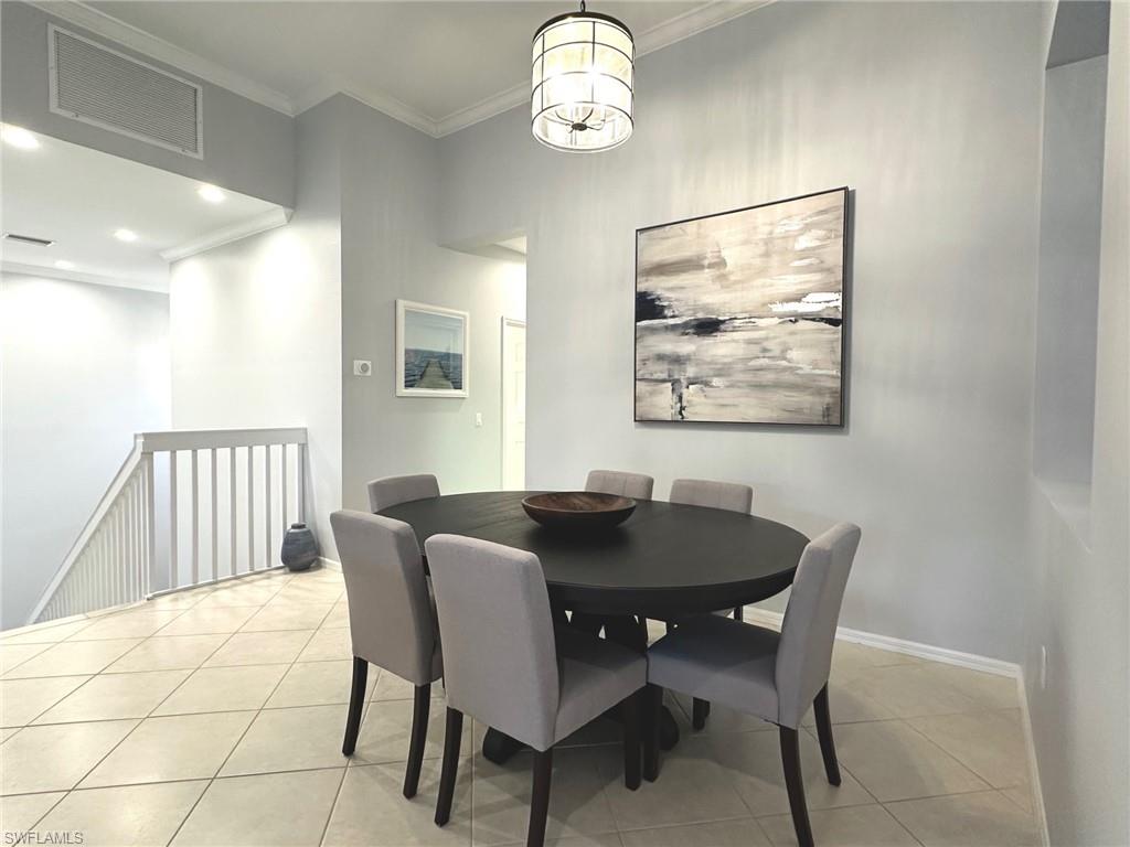 12259 Toscana Way, Unit 202 Bonita Springs, FL 34135 - Photo 3 of 40 a view of a dining room with furniture