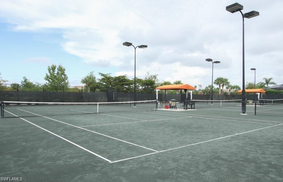 12259 Toscana Way, Unit 202 Bonita Springs, FL 34135 - Photo 35 of 40 a view of a tennis court with lots of palm trees