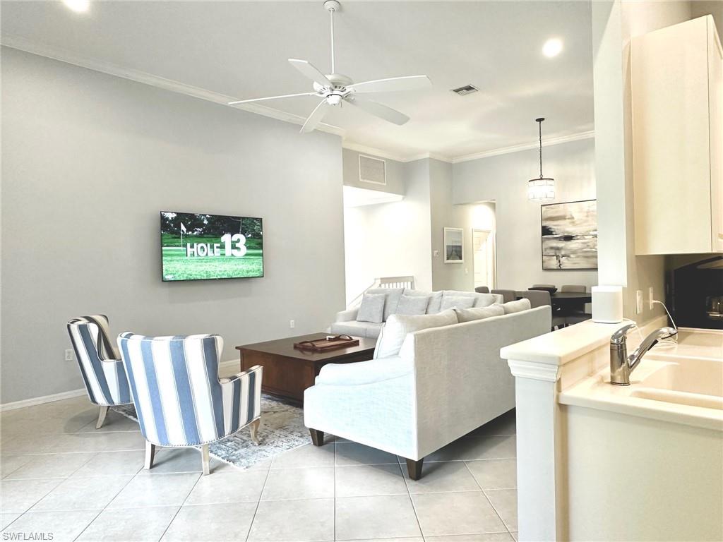 12259 Toscana Way, Unit 202 Bonita Springs, FL 34135 - Photo 8 of 40 a living room with furniture and a table