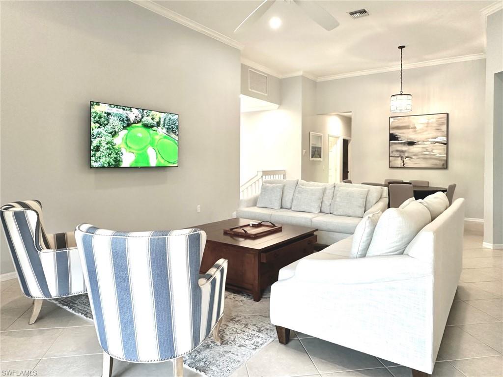 12259 Toscana Way, Unit 202 Bonita Springs, FL 34135 - Photo 9 of 40 a living room with furniture and a flat screen tv