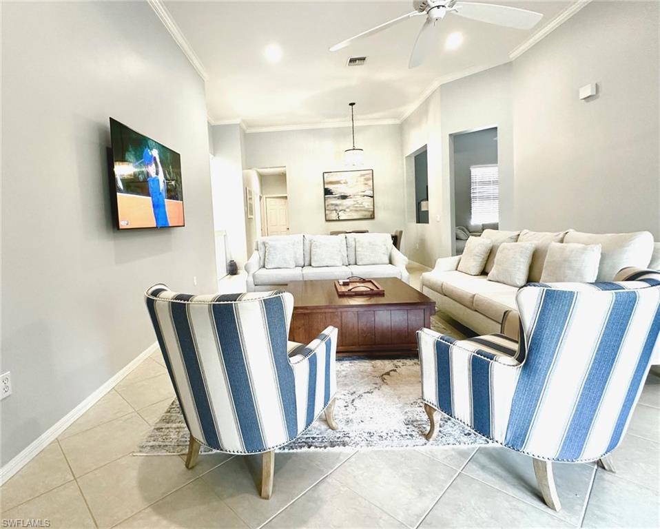 12259 Toscana Way, Unit 202 Bonita Springs, FL 34135 - Photo 10 of 40 a living room with furniture and a flat screen tv