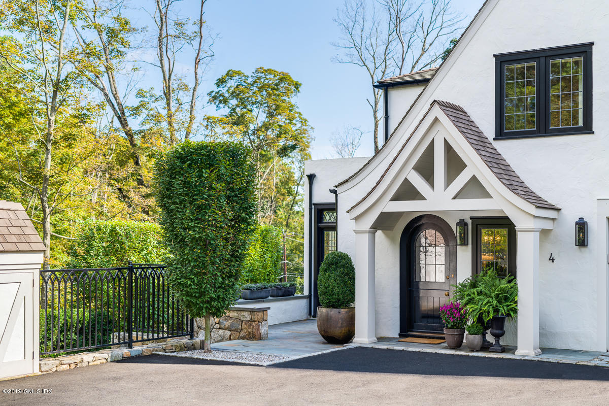 4 Cedar Hill Greenwich, CT 06830 - Photo 26 of 28 a front view of a house with garden