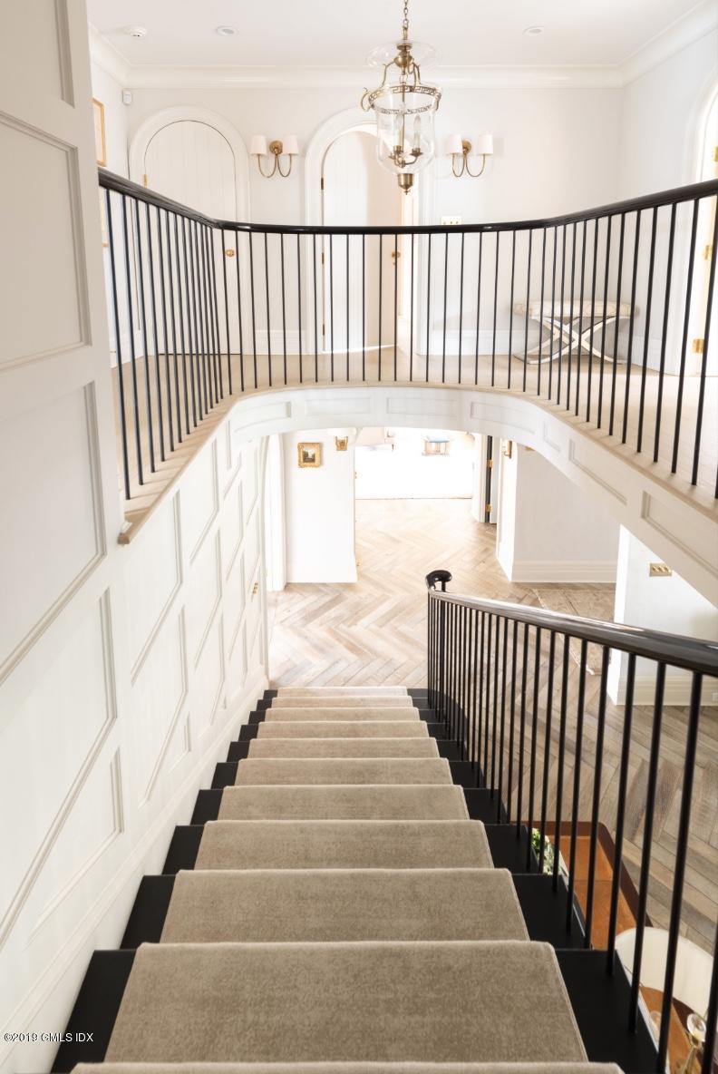 4 Cedar Hill Greenwich, CT 06830 - Photo 8 of 28 a view of staircase with white walls and a floor to ceiling window