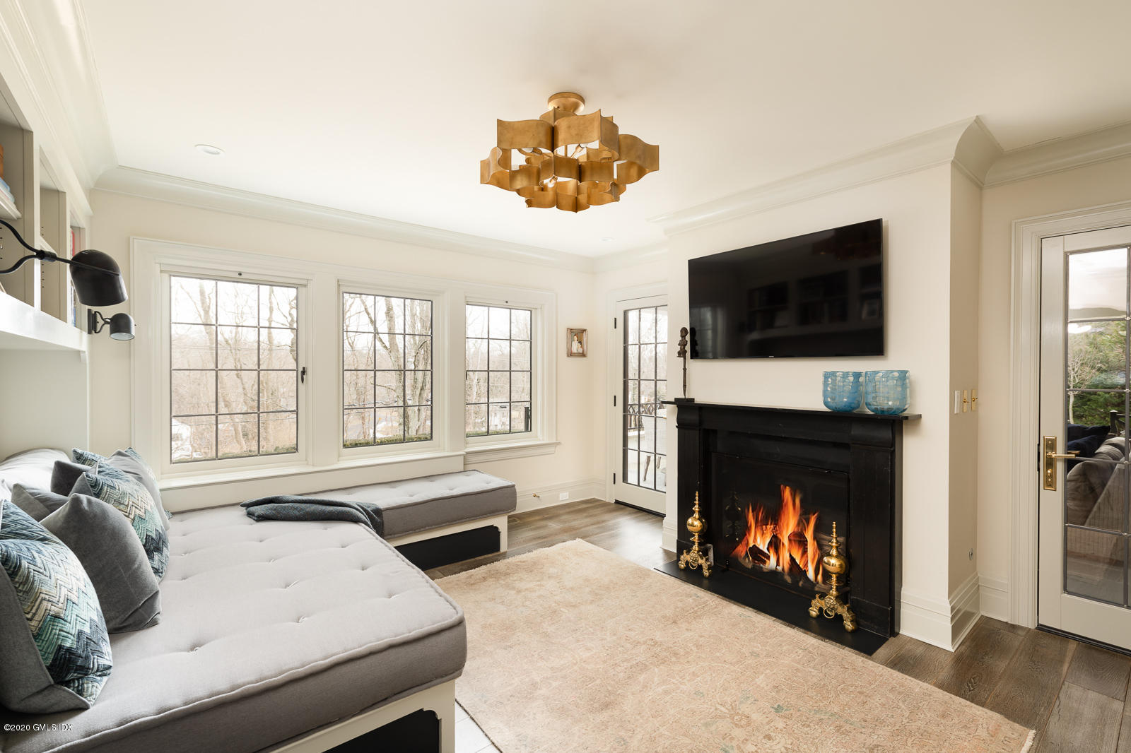 4 Cedar Hill Greenwich, CT 06830 - Photo 10 of 28 a living room with furniture a fireplace and a flat screen tv