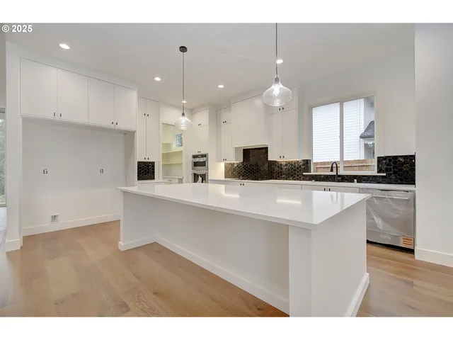 a kitchen with kitchen island sink stove and refrigerator