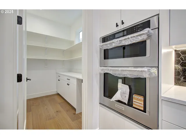 a kitchen with granite countertop white cabinets stainless steel appliances and sink