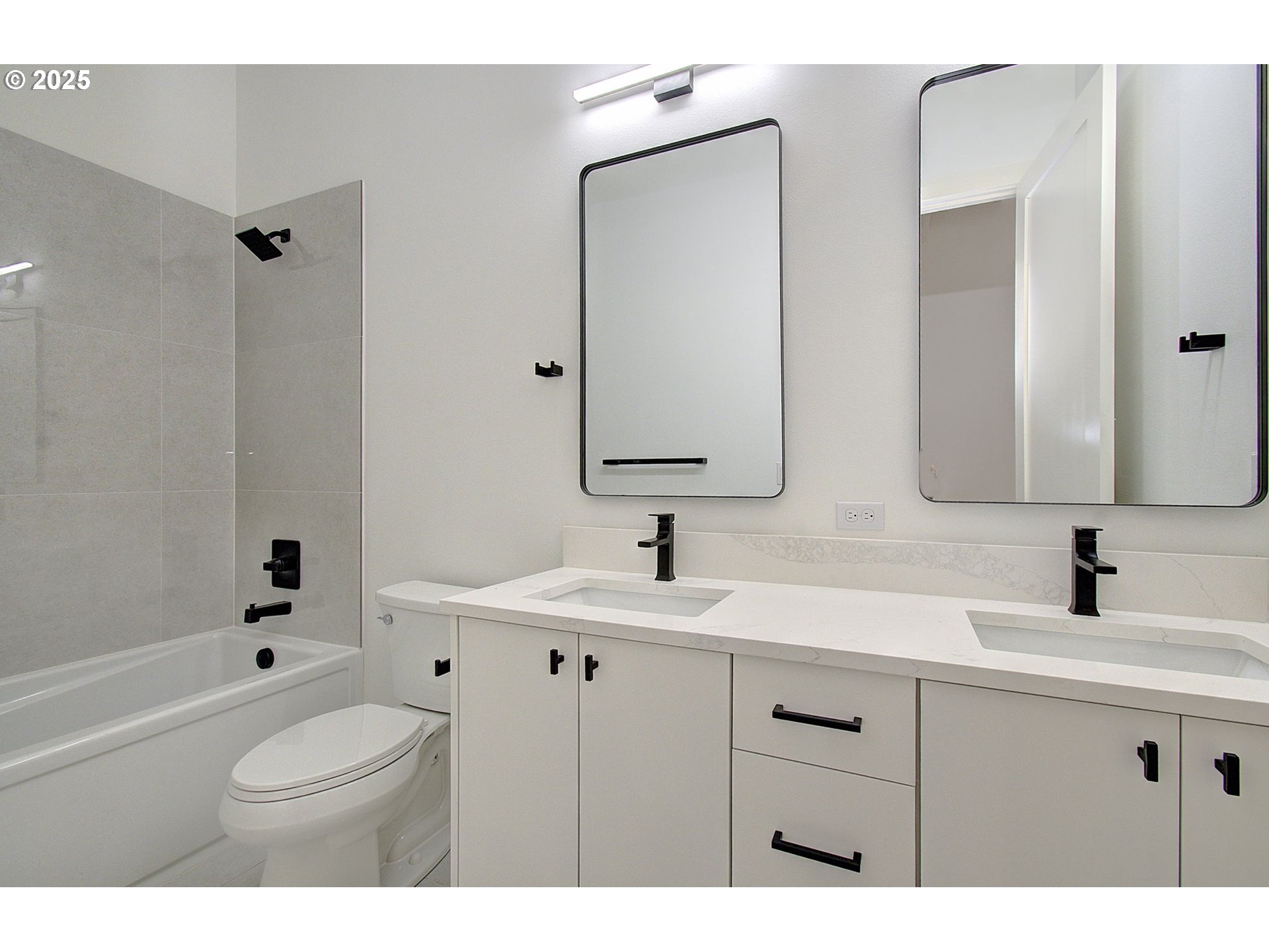 2010 Northeast 159th Street Ridgefield, WA 98642 - Photo 20 of 42 a bathroom with a toilet a sink a tub and mirror