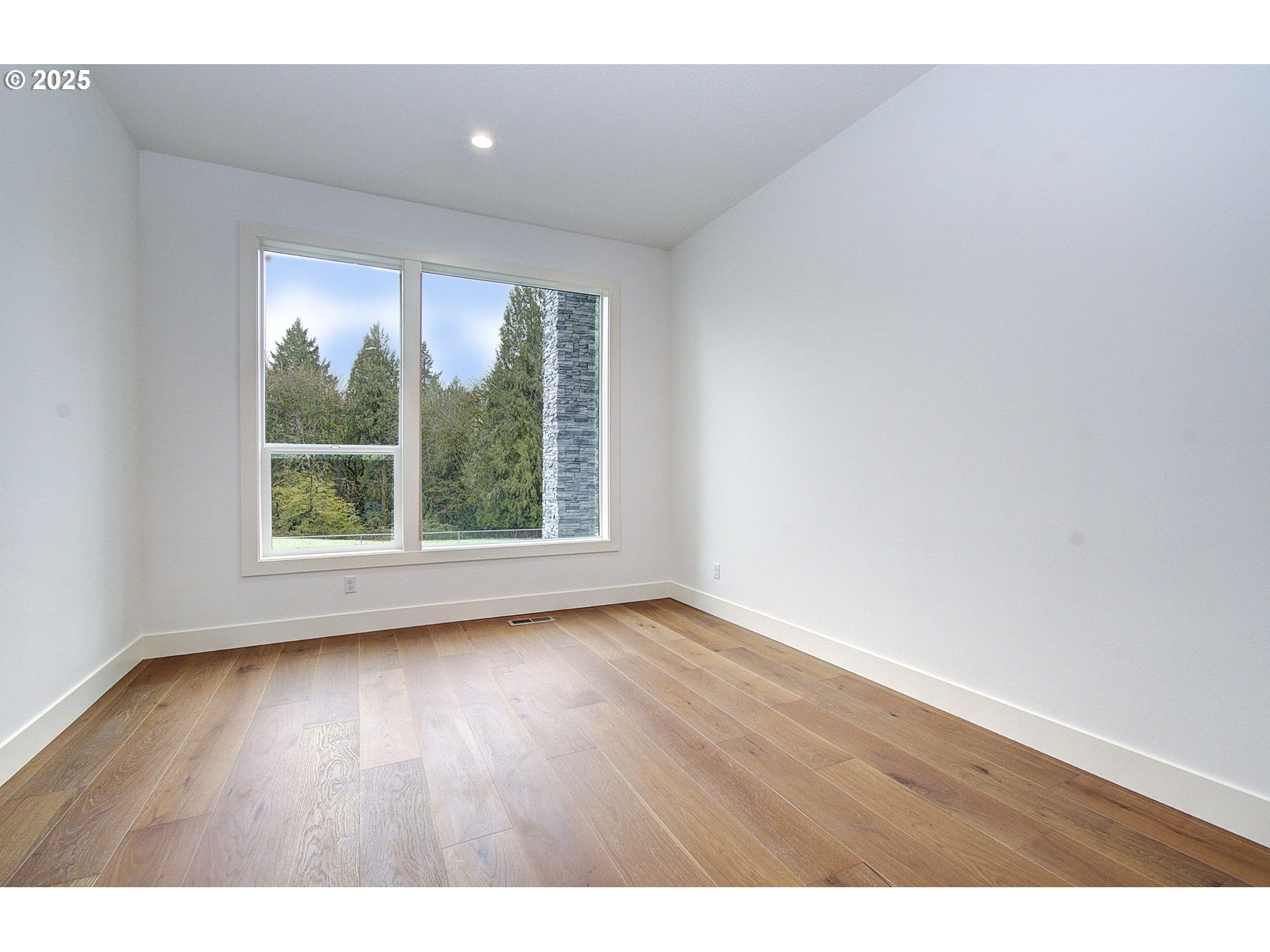 2010 Northeast 159th Street Ridgefield, WA 98642 - Photo 21 of 42 a view of an empty room with wooden floor and a window
