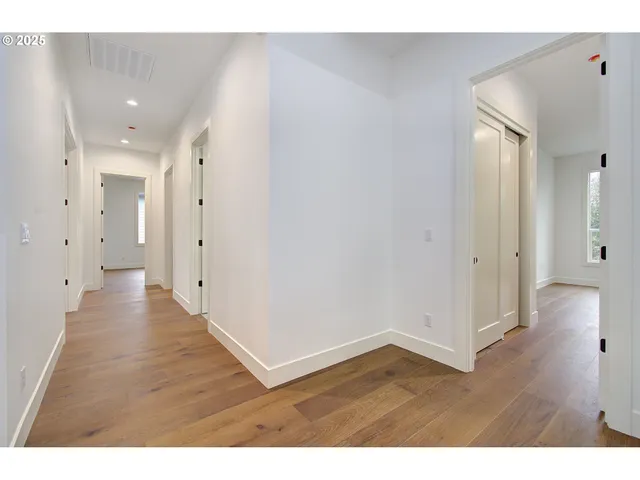 a view of a kitchen with white cabinets