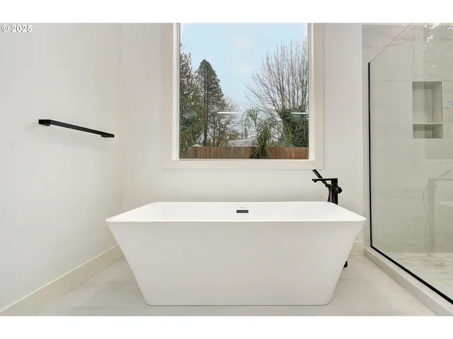 a bathroom with a sink a mirror and a shower