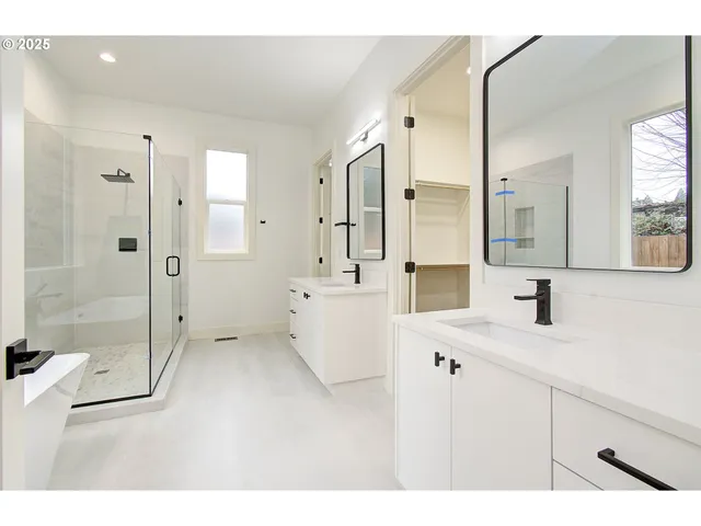 a bathroom with a sink double vanity and a mirror