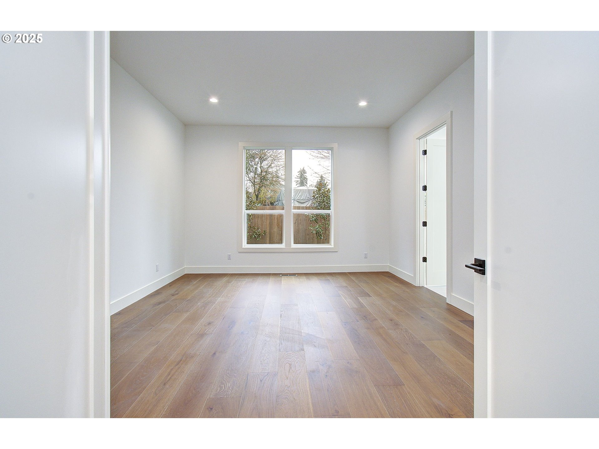2010 Northeast 159th Street Ridgefield, WA 98642 - Photo 33 of 42 a view of an empty room with wooden floor and a window