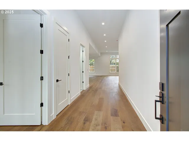 a view of hallway with wooden floor
