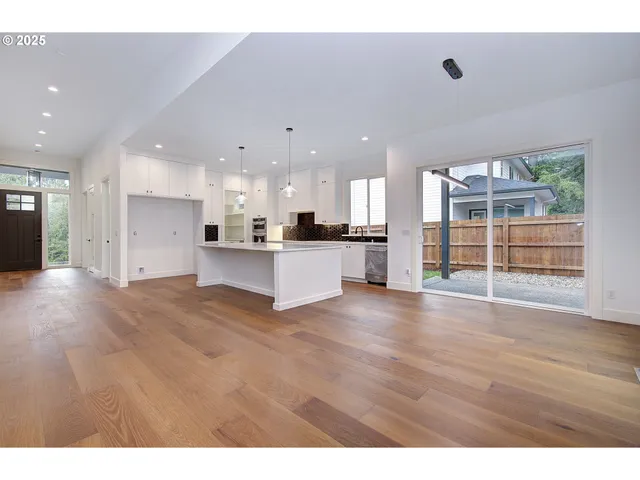 a view of a kitchen with a sink and a stove top oven