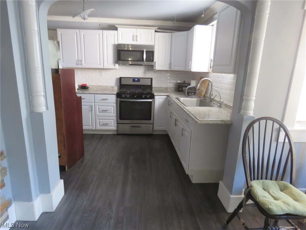 10451 Lagrange Road Elyria, OH 44035 - Photo 9 of 21 Kitchen with white cabinets, dark hardwood / wood-style floors, and stainless steel appliances