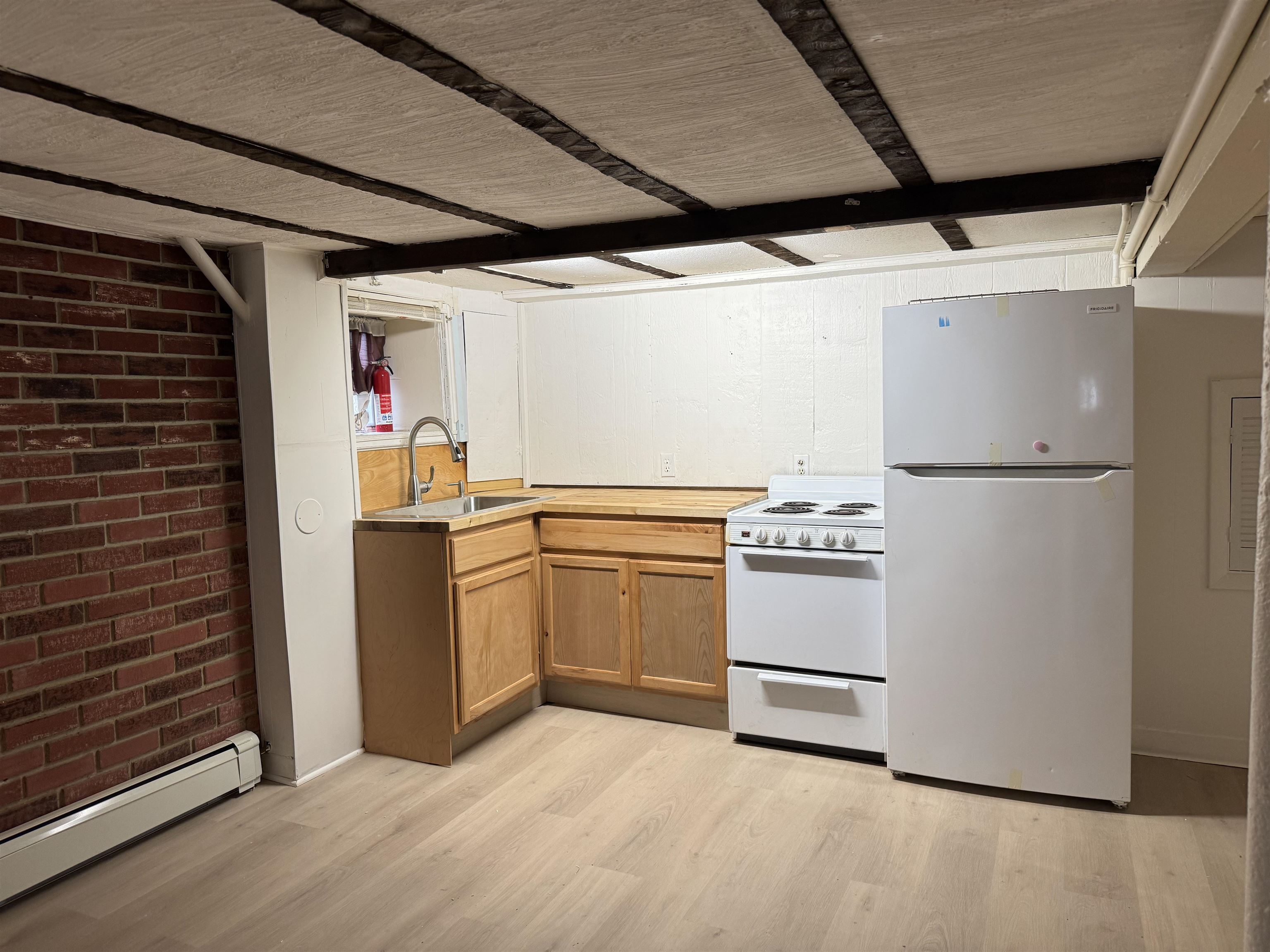 a kitchen with a refrigerator and white cabinets