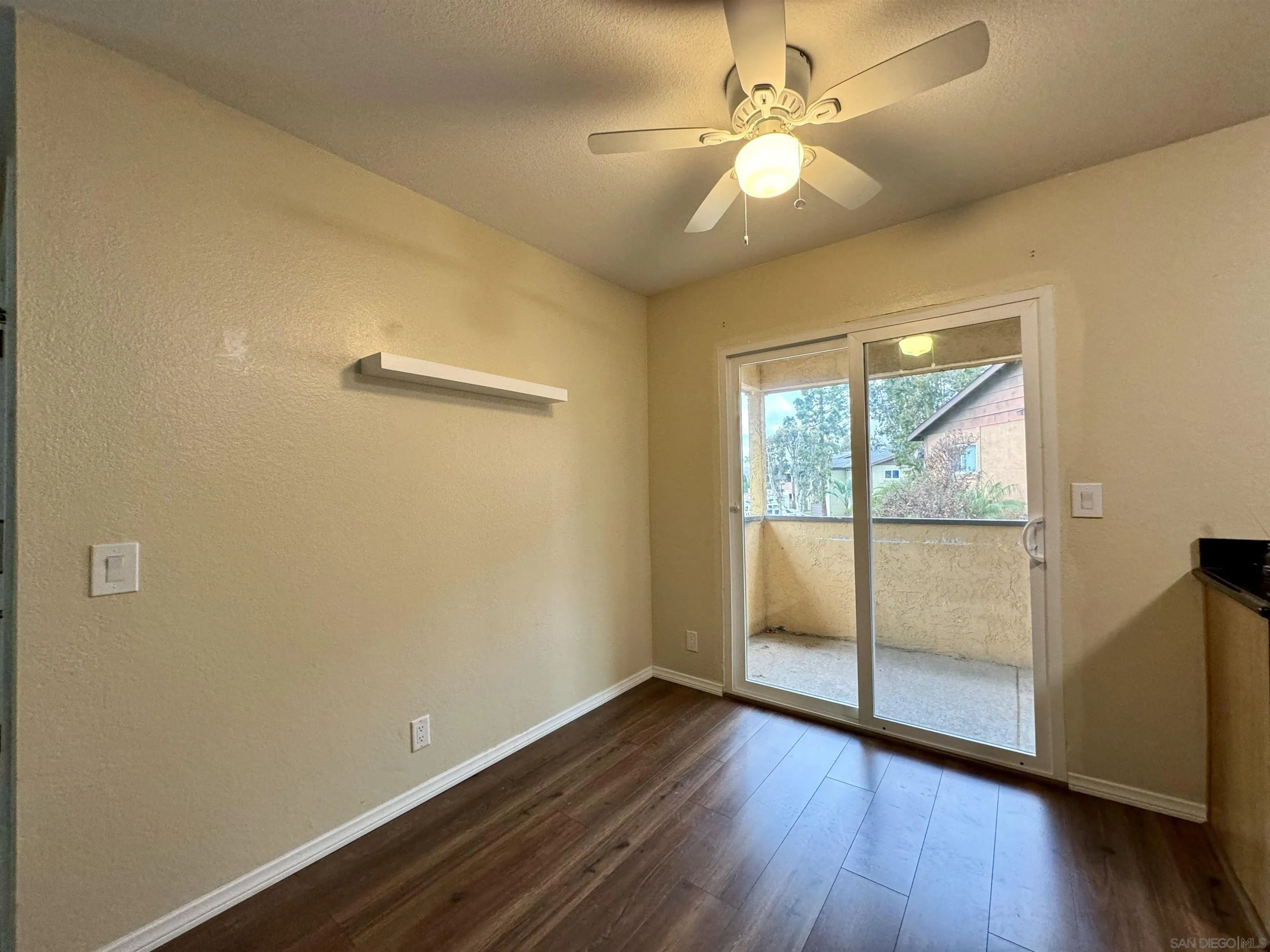 506 Calle Montecito, Unit 40 Oceanside, CA 92057 - Photo 3 of 19 an empty room with wooden floor fan and windows
