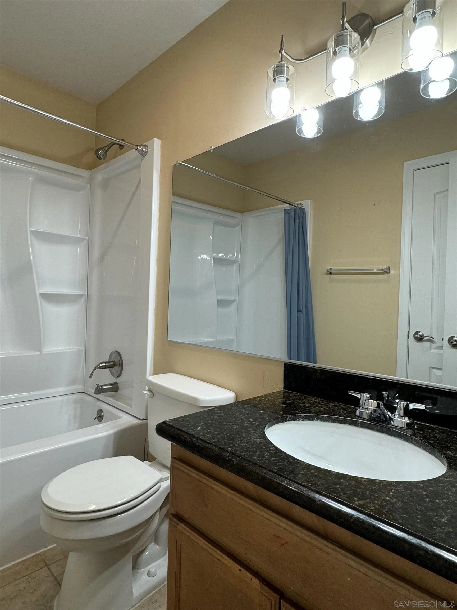 506 Calle Montecito, Unit 40 Oceanside, CA 92057 - Photo 6 of 19 a bathroom with a granite countertop sink and a mirror