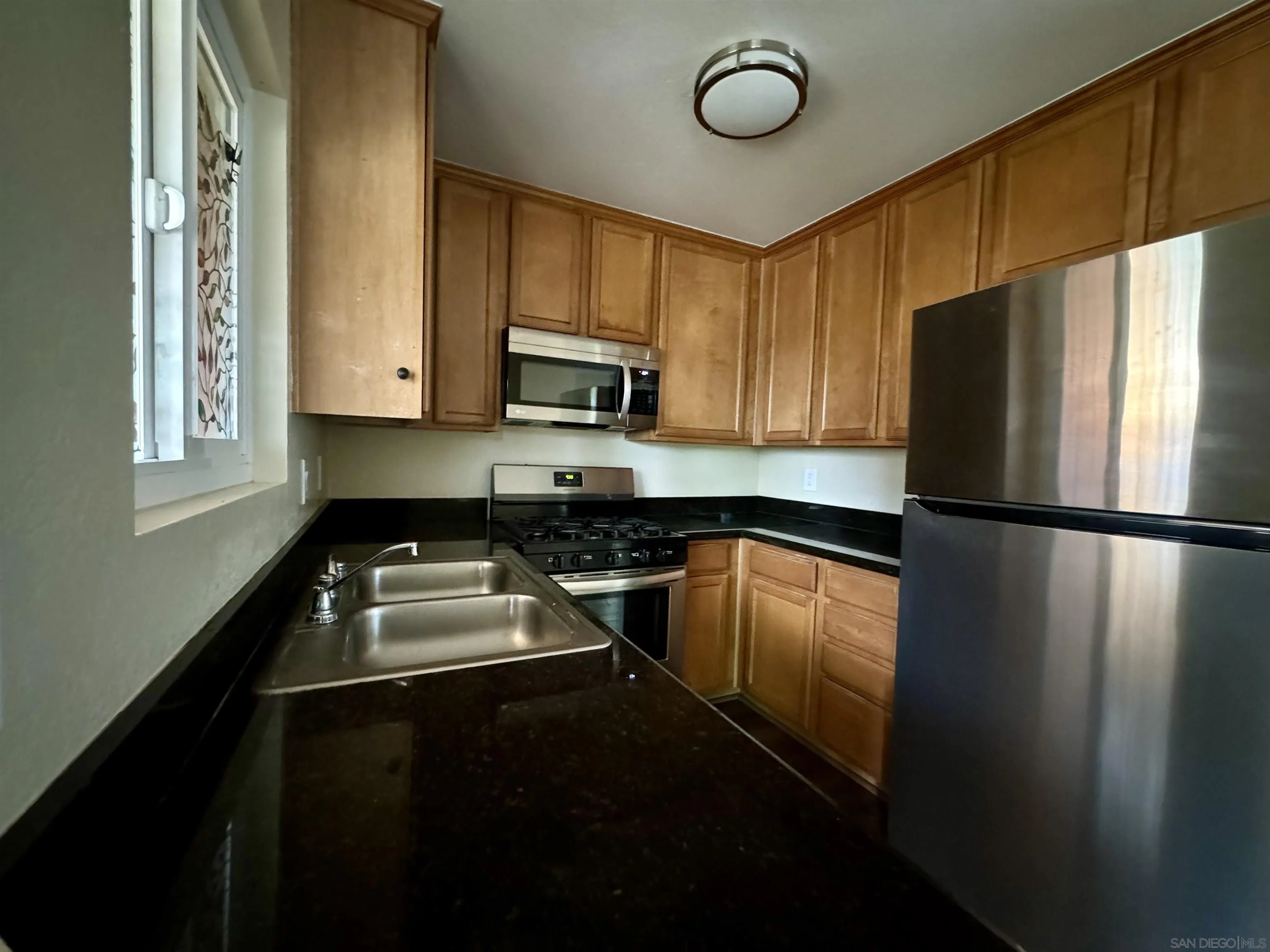 506 Calle Montecito, Unit 40 Oceanside, CA 92057 - Photo 7 of 19 a kitchen with a refrigerator a stove and a sink