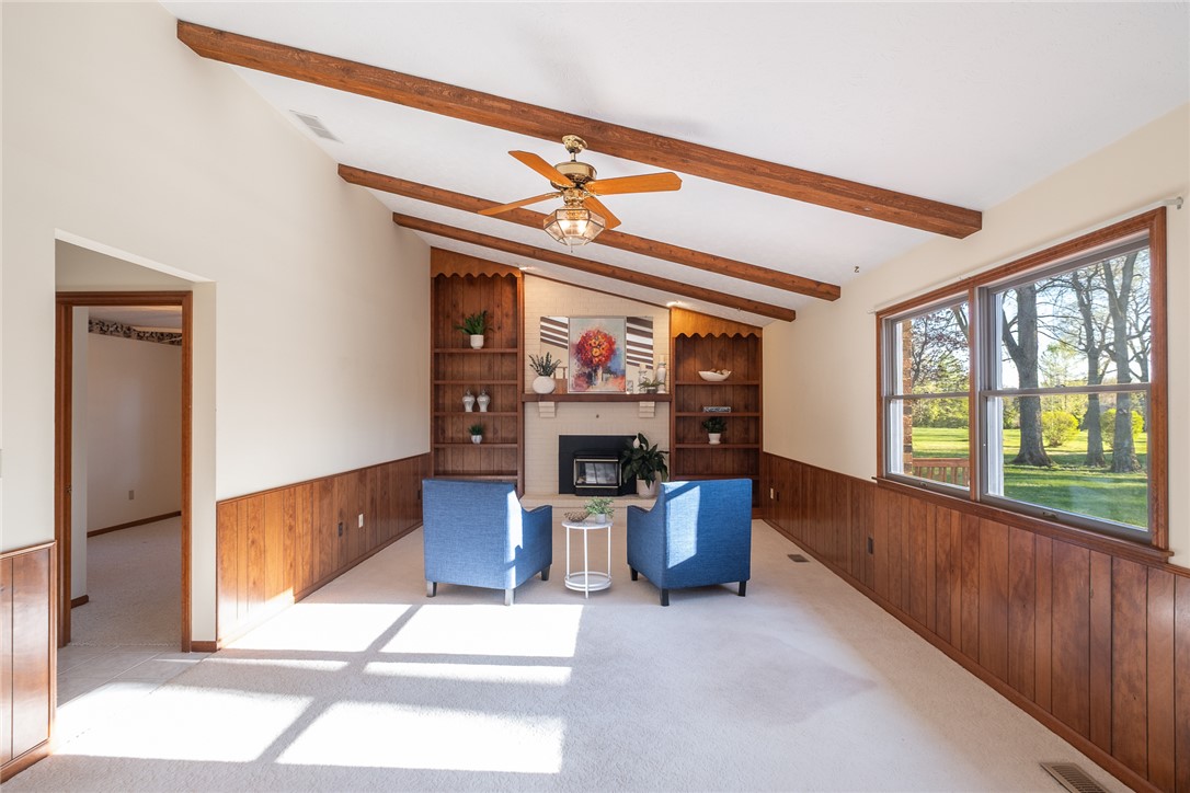 276 South Fairfield Road Bellbrook, OH 45305 - Photo 13 of 38 This bright living area features built-in shelving, a cozy fireplace, and abundant natural light.