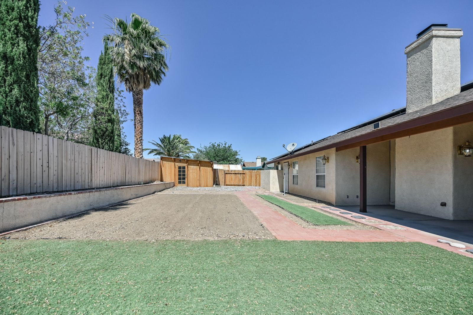 1209 West Robert Avenue Ridgecrest, CA 93555 - Photo 45 of 50 a backyard of a house with lots of green space