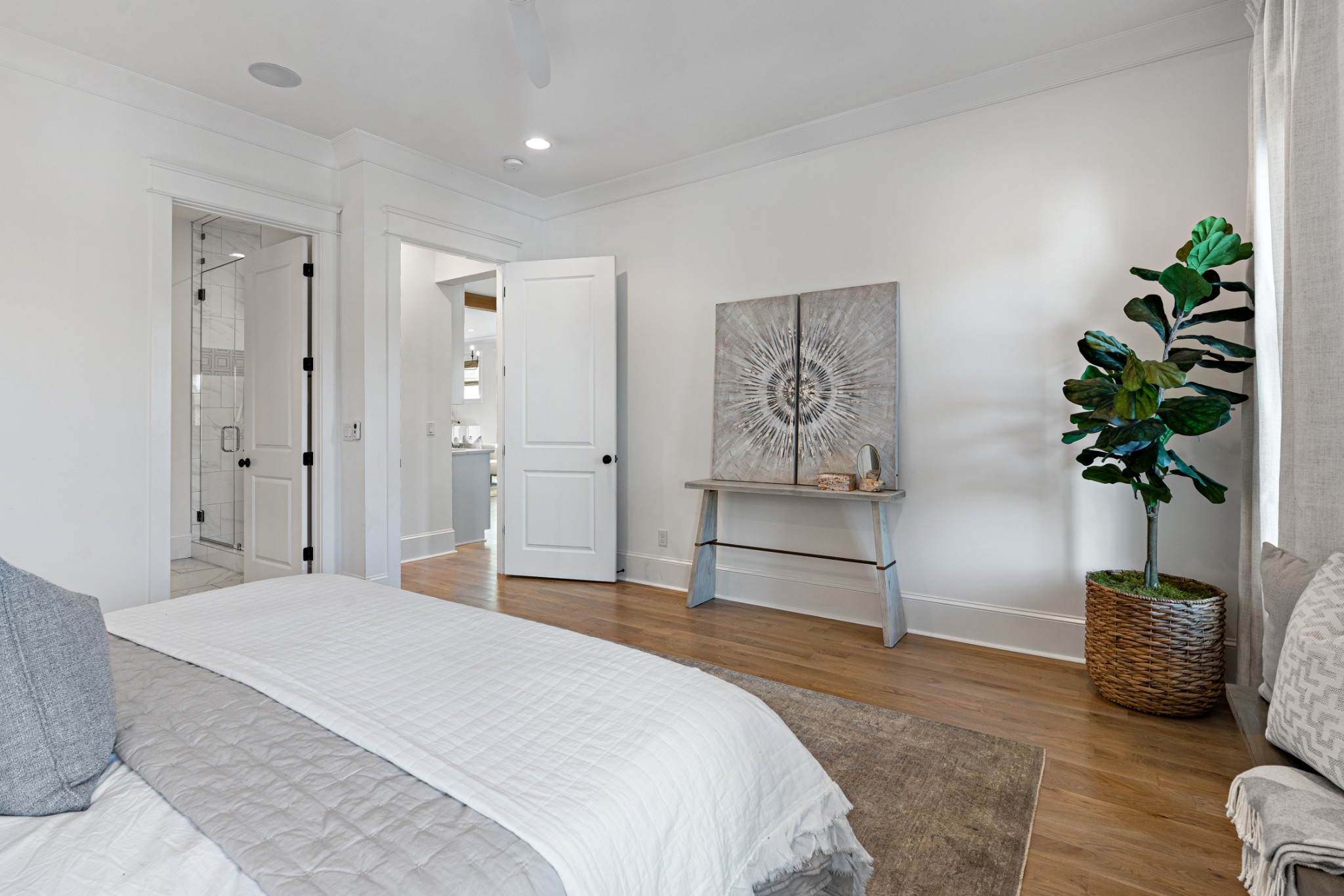 110 Lindsley Park Drive Nashville, TN 37206 - Photo 13 of 32 a spacious bedroom with a bed and a potted plant