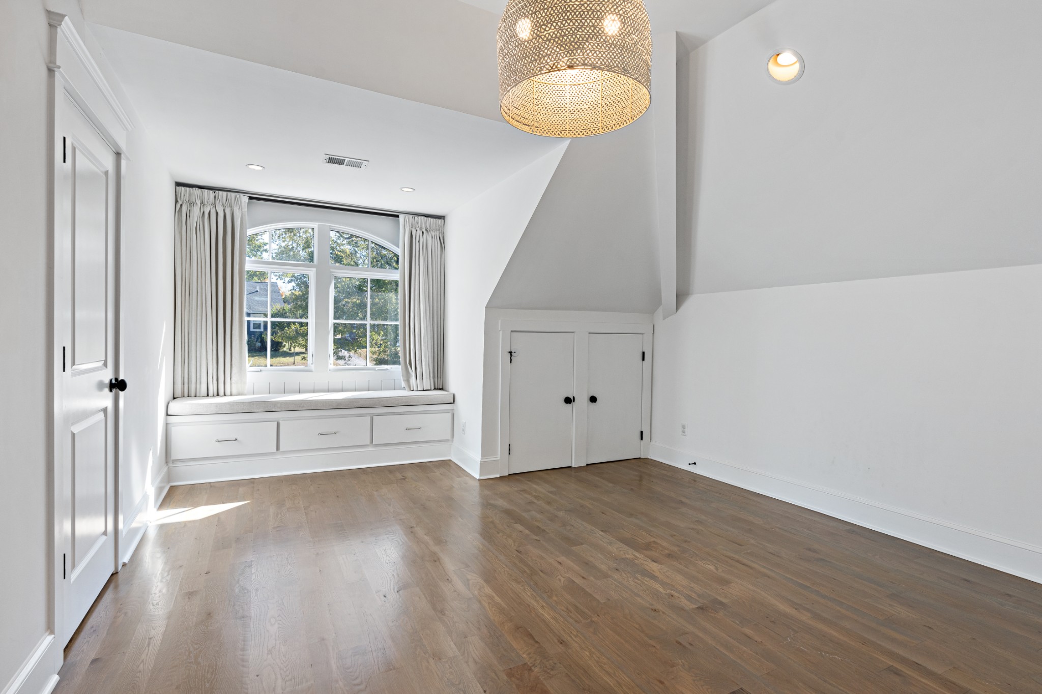 110 Lindsley Park Drive Nashville, TN 37206 - Photo 18 of 32 a view of an empty room with wooden floor and a window
