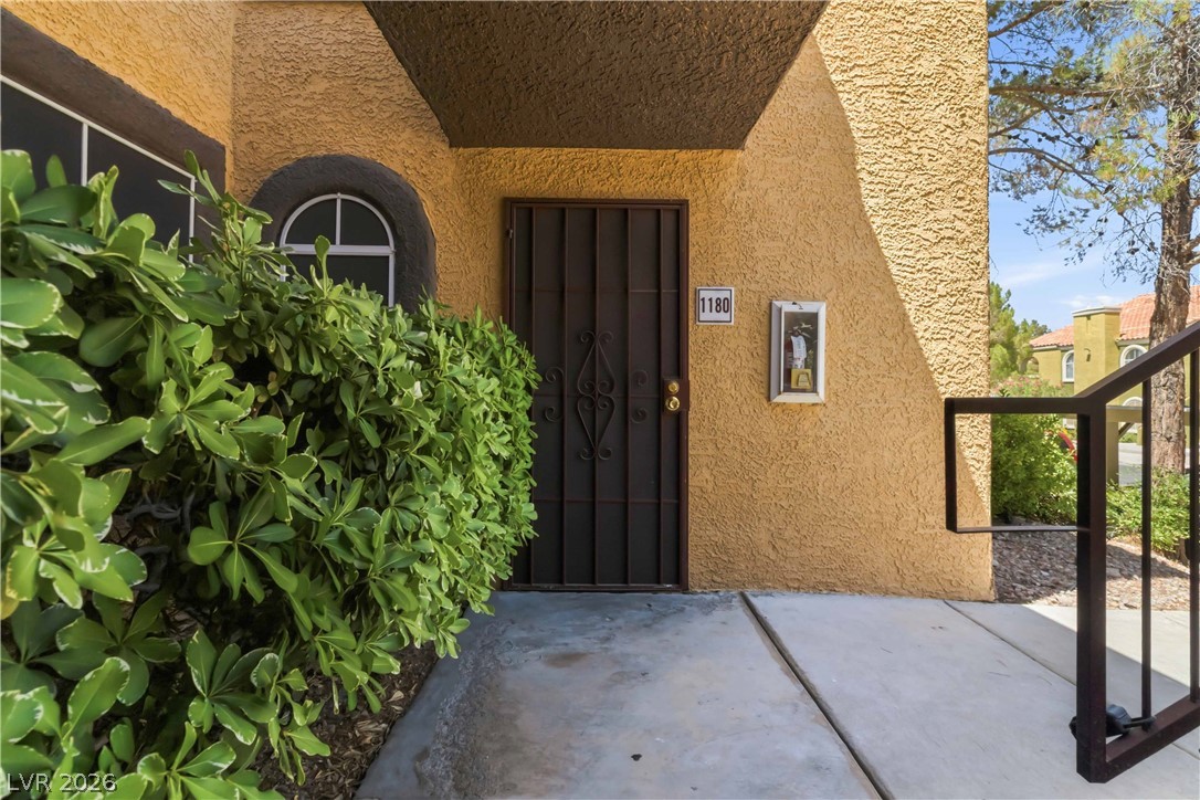 7950 West Flamingo Road, Unit 1180 Las Vegas, NV 89147 - Photo 3 of 26 A secure entry with an ornamental iron gate provides privacy to this inviting home.
