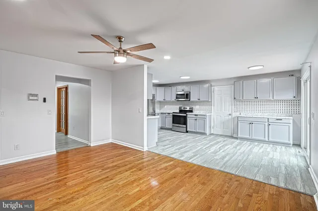 a kitchen with granite countertop a stove top oven sink and cabinets