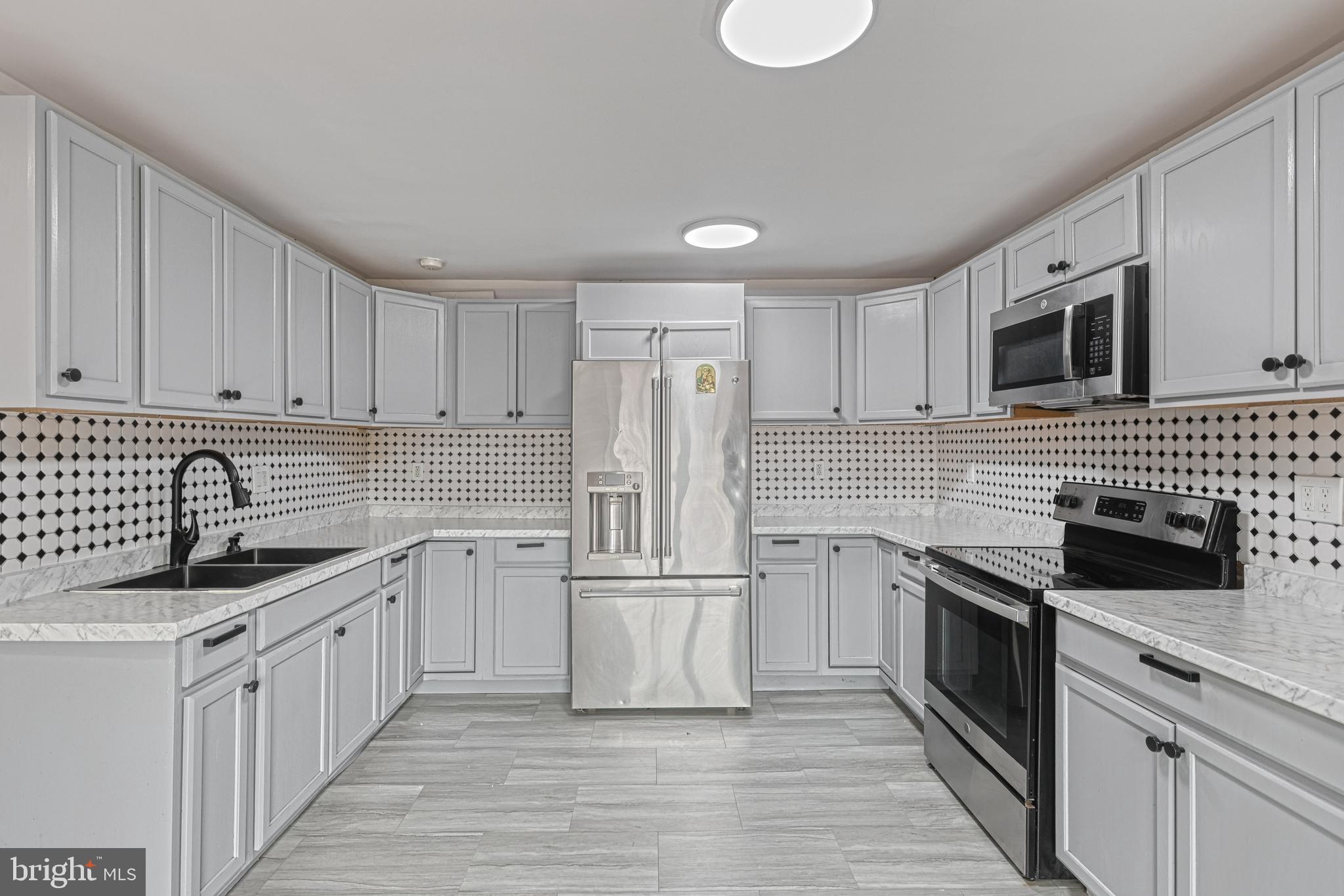1373 Quail Hollow Road Harrisburg, PA 17112 - Photo 21 of 68 a kitchen with stainless steel appliances granite countertop a sink stove and refrigerator