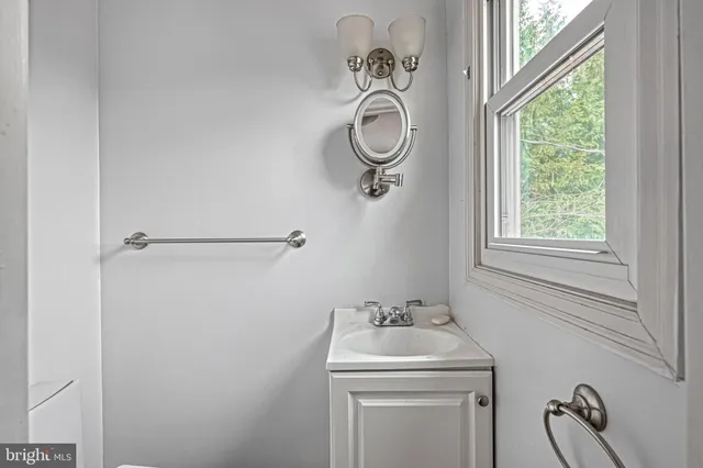 a bathroom with a granite countertop sink a mirror and a vanity