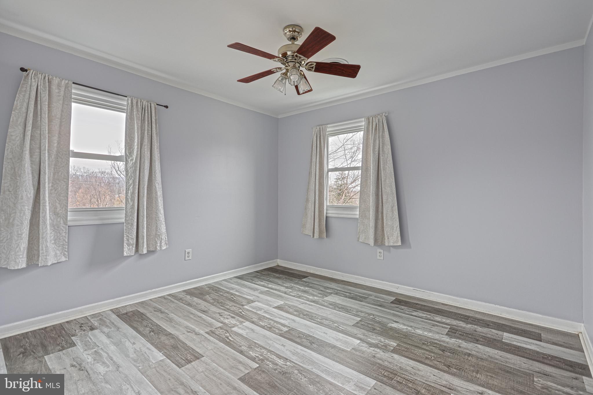 1373 Quail Hollow Road Harrisburg, PA 17112 - Photo 32 of 68 a view of empty room with wooden floor and fan