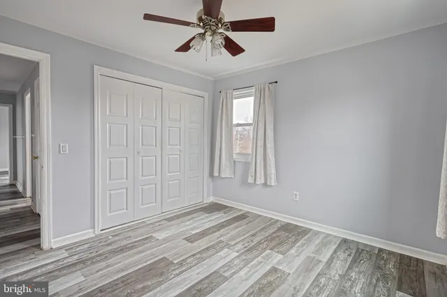 a view of an empty room with wooden floor