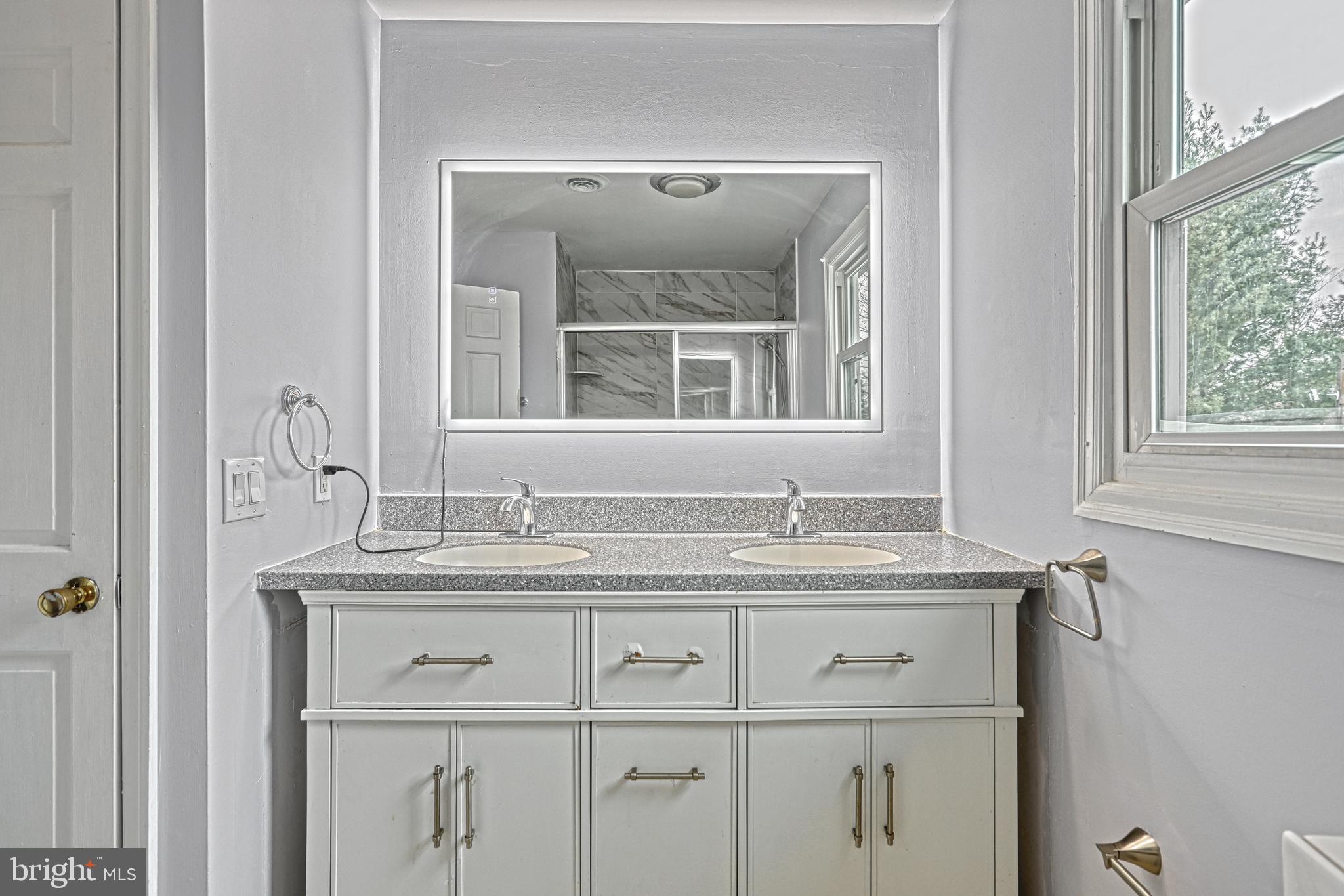 1373 Quail Hollow Road Harrisburg, PA 17112 - Photo 34 of 68 a bathroom with a granite countertop sink and a mirror