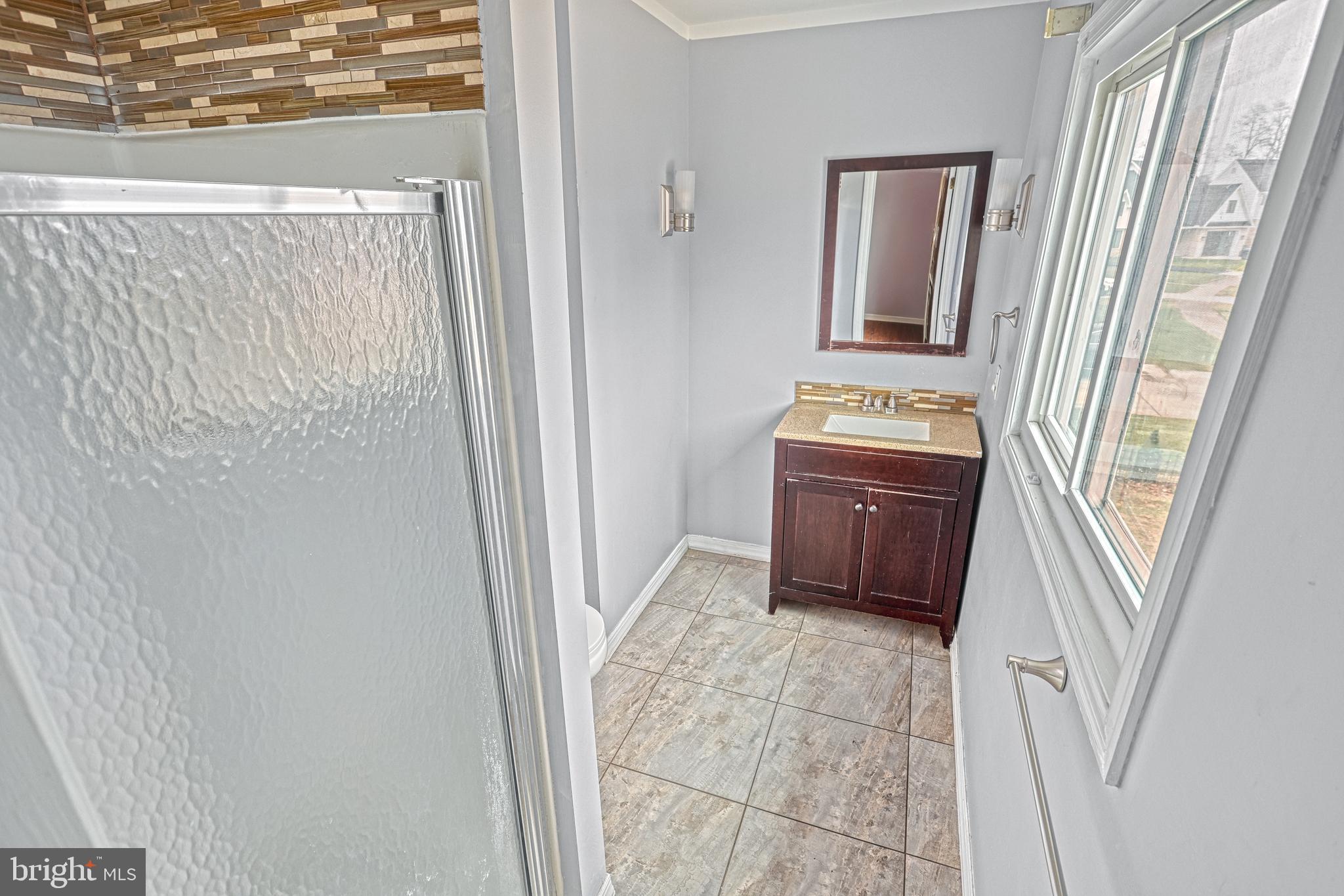1373 Quail Hollow Road Harrisburg, PA 17112 - Photo 38 of 68 a bathroom with a granite countertop sink a mirror and a vanity