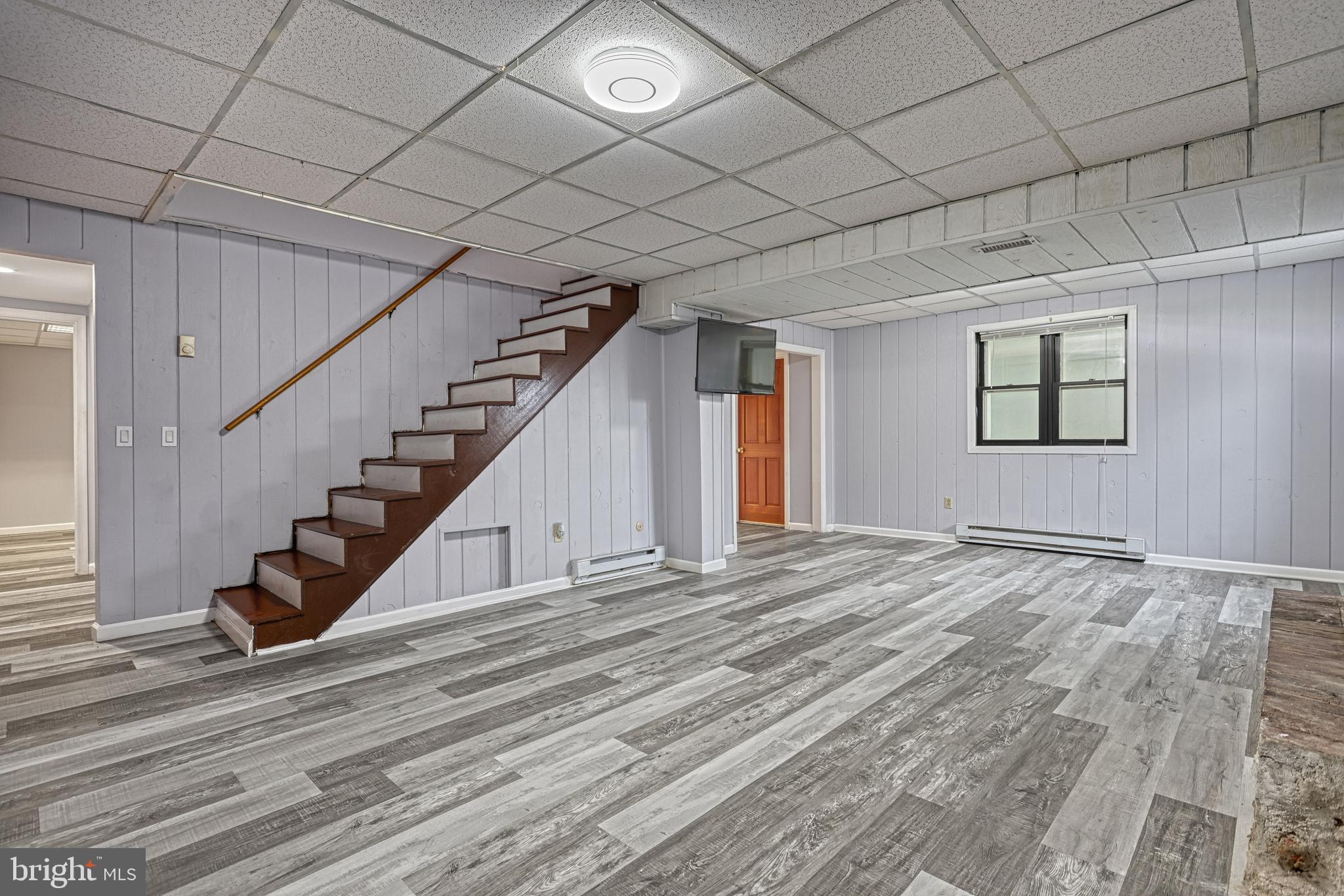 1373 Quail Hollow Road Harrisburg, PA 17112 - Photo 42 of 68 a view of an empty room with wooden floor and stairs