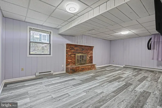a view of a bedroom with furniture and wooden floor