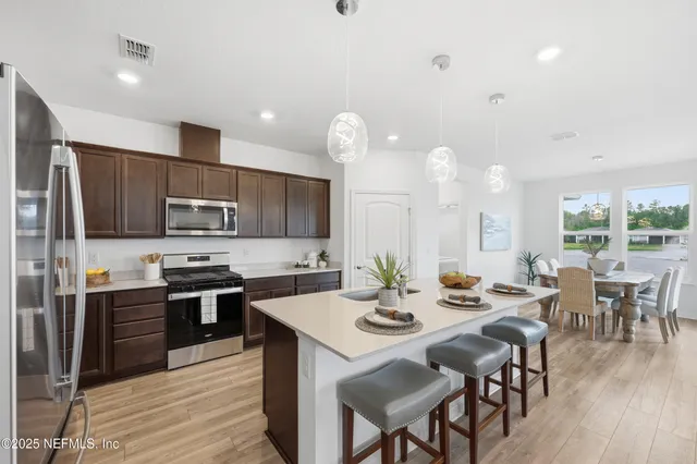 an aerial view of a swimming pool with outdoor seating